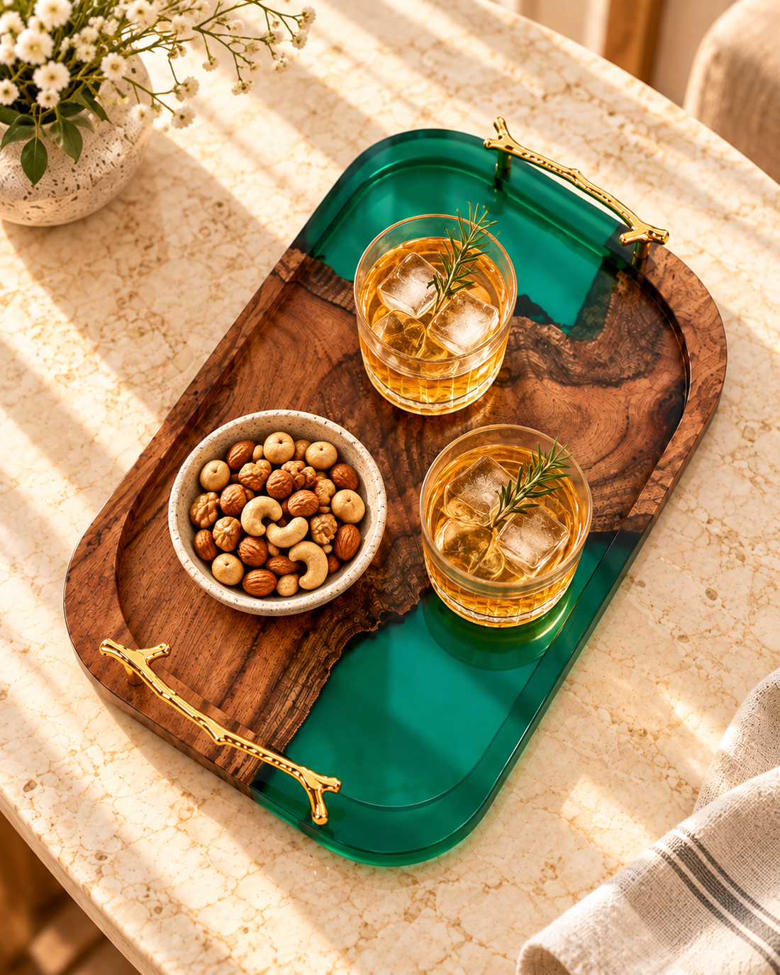 Overhead view of wood and emerald epoxy resin serving tray with drinks and nuts